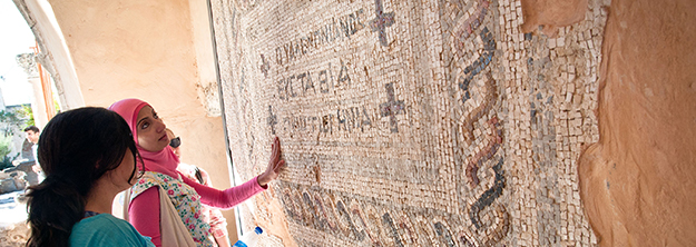 Students studying a mosaic